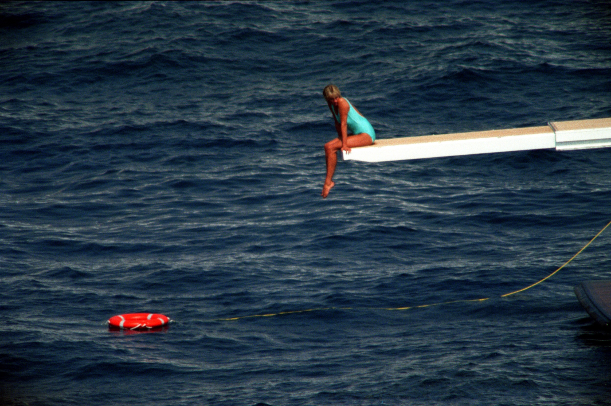 Diana, Princess of Wales seated on Isabell's diving board at sea, 1997